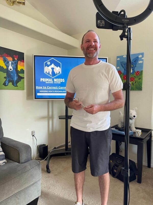 A man standing in front of a tv and a microphone.